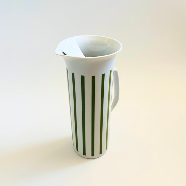 A tall mid century porcelain pitcher. Designed by LaGardo Tackett for Schmid International Porcelain as part of the...
