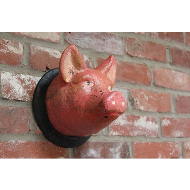Black Forest carved and hand-painted 'pig' sculpture mounted to a circular board for wall hanging (ca. 1930s/40s,...