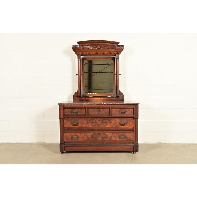 A gorgeous antique Eastlake Victorian vanity dresser with mirror In the manner of Herter Brothers USA, Circa 1880s Carved...