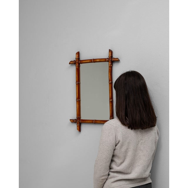 This 19th Century French faux bamboo mirror exemplifies the charm and craftsmanship of the periods Japonisme-inspired...