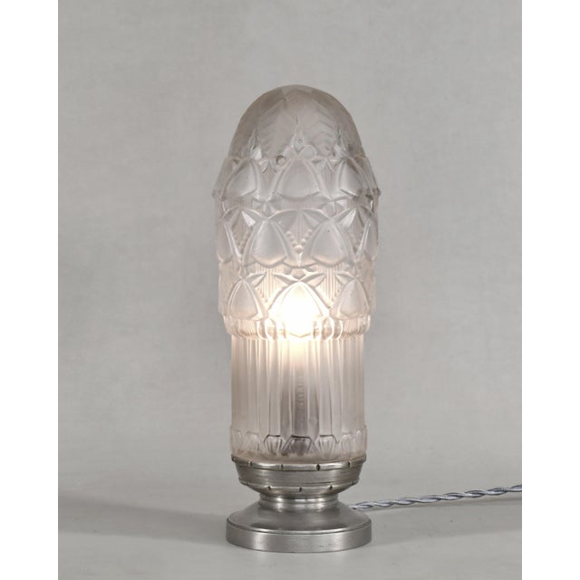 Simonet frères & Dieupart A beautiful French 1925-1930 art deco lamp in nickel plated solid brass or bronze holding a...