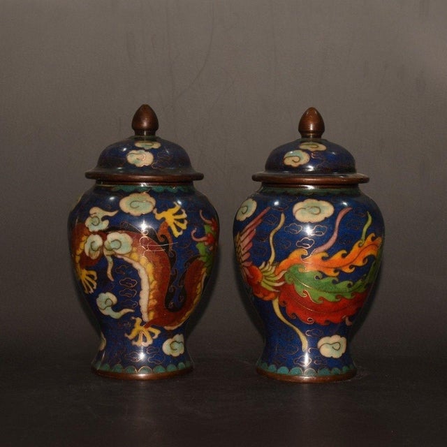 This is a striking and highly decorative matching pair of vintage Chinese cloisonné jars, traditionally referred to as...