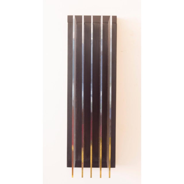 This artwork presents a series of five acrylic panels that play with light and shadow, creating an ethereal atmosphere....