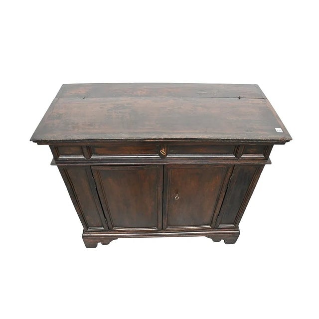 This 18th/19th century Spanish kitchen cabinet or cupboard is a handmade antique piece crafted with wood in a brown color....