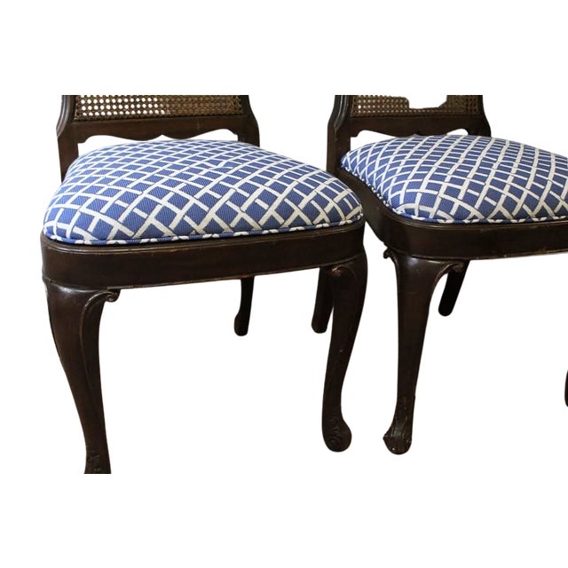 The seats have been upholstered in a fresh blue geometric lattice fabric that provides a crisp, updated contrast to the...