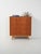 Scandinavian teak chest of drawers from the 1950s with four drawers, brass handles, and a contrasting oak base, for a...