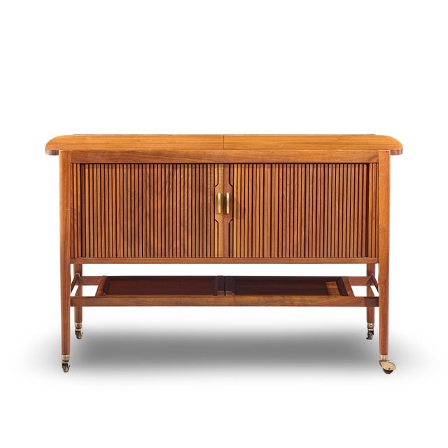 Kipp Stewart for Drexel Declaration Mid Century Walnut Tambour Door Bar Cart This bar cart measures: 49.5 wide x 18 deep x...