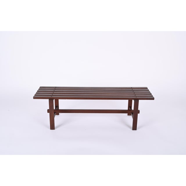 Marvellous mid-century bench made of dark brown teak wood. This astonishing item is a Scandinavian production from the...