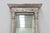 An impressive pair of Italian neoclassical pier mirrors dating to the mid-19th century, distinguished by their...