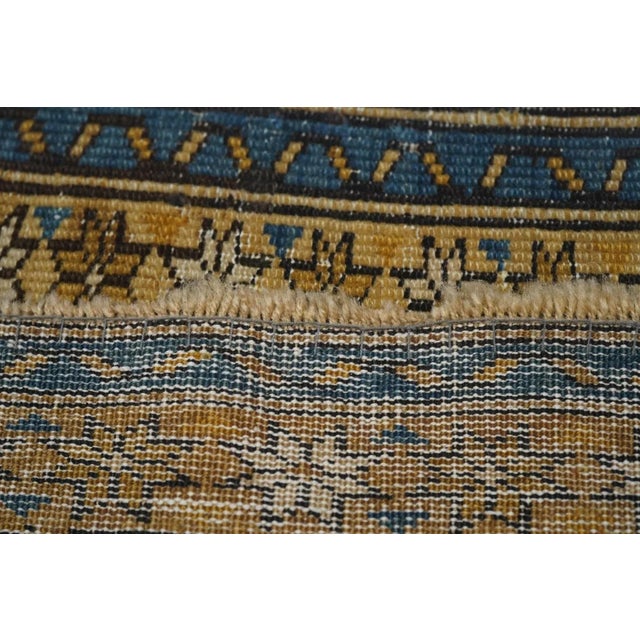 This eastern Caucasian ruglet shows the iconic rams horns and "daggers" repeating pattern around cream ashiks, on a navy...