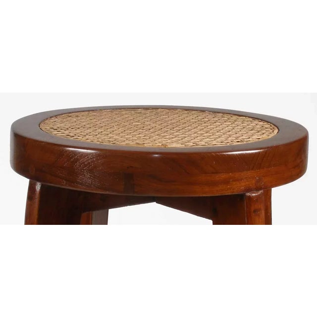 DETAILS Crafted of solid teak with a round caned seat supported on four tapered legs joined by an X-stretcher. Two...