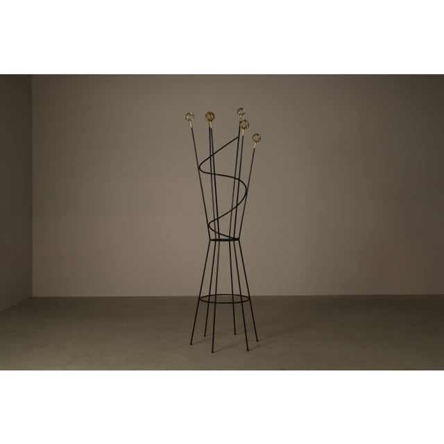 Decorative contemporary freestanding coat and hat stand in the style of the playful mid-century designs associated with...