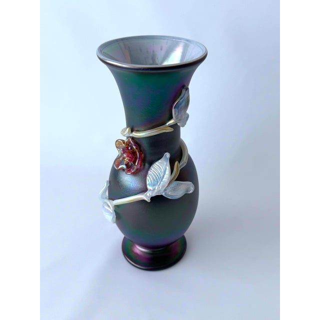 Iridescent black glass vase in an art nouveau hand-formed glass floral decor in the style of Loutz. You can say of vase...