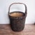 Antique Chinese woven fisherman’s rattan and cane basket with bent handle. This basket was handmade in the mid 1800s in...