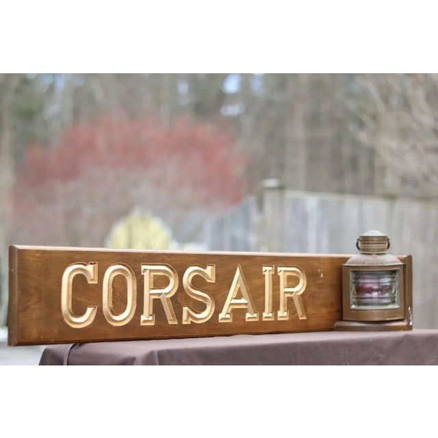 Mahogany namenord reading "Corsair" with authentic port lantern. Dimensions: 42" L x 6" W x 10" H.