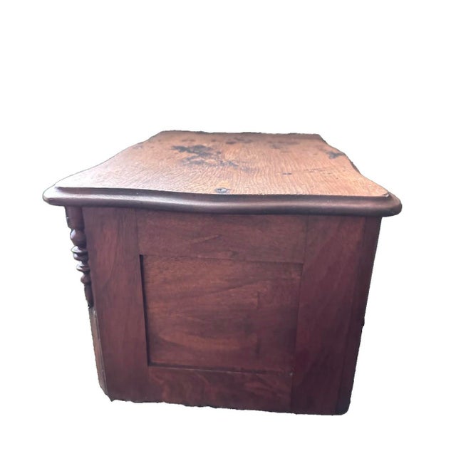 Solid wood Victorian-era storage chest. Rustic in appearance. Smaller sized to sit on a table top. Carved side columns and...