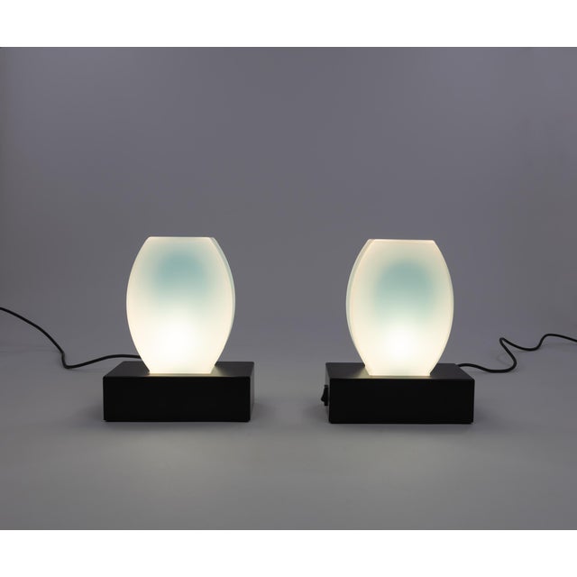 Pair of blue Dorane table lamps designed in 1977 by Ettore Sottsass and manufactured by Stilnovo. The base of these lamps...