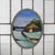 An antique Arts & Crafts window offers leaded glass construction with colorless panels surrounding central reserve with...
