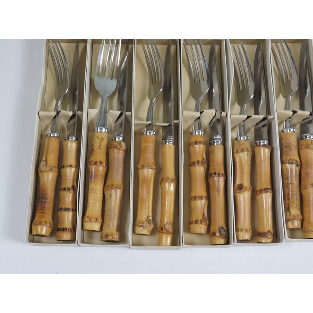 Mid-century German steak cutlery set for twelve, dating from the 1960s. This complete ensemble comprises 12 steak knives...