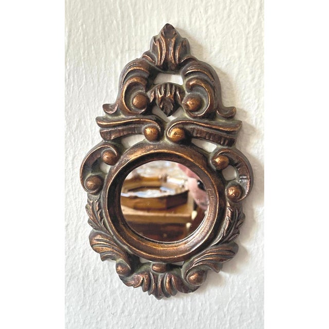 A jewel of a mirror with serious Old World presence. This 1960s Venetian-style wall mirror is wrapped in a heavy gilded...