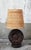 A brutalist table lamp by delsinne, featuring a solid wood base sculpted in relief to evoke a stylized sun. The base, with...