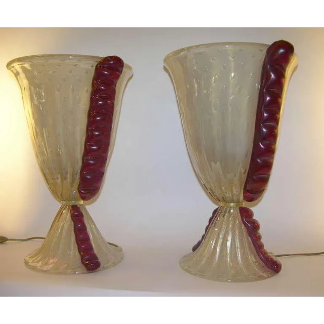 An Italian pair of exceptional 1970s Barovier e Toso lamps, the flared ribbed bodies in blown overlaid frosted Murano...