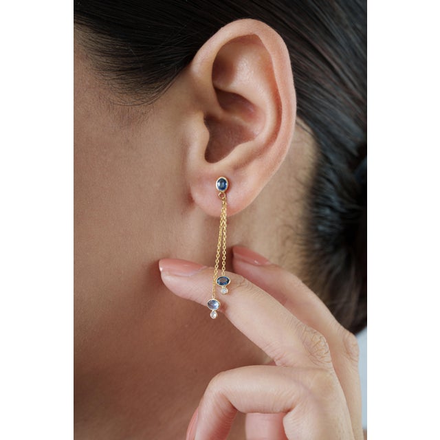 These linear drop earrings showcase 1.2 carats of natural blue sapphires, set in 18k yellow gold. Each sapphire measuring...