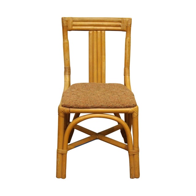 Mid Century to 1970s bent rattan chair inspired by bamboo stalk furniture. The seat cover in brown tweed matches the wood...