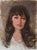 This oil on canvas portrait captures a woman with soft, contemplative features against a muted background. The warm tones...
