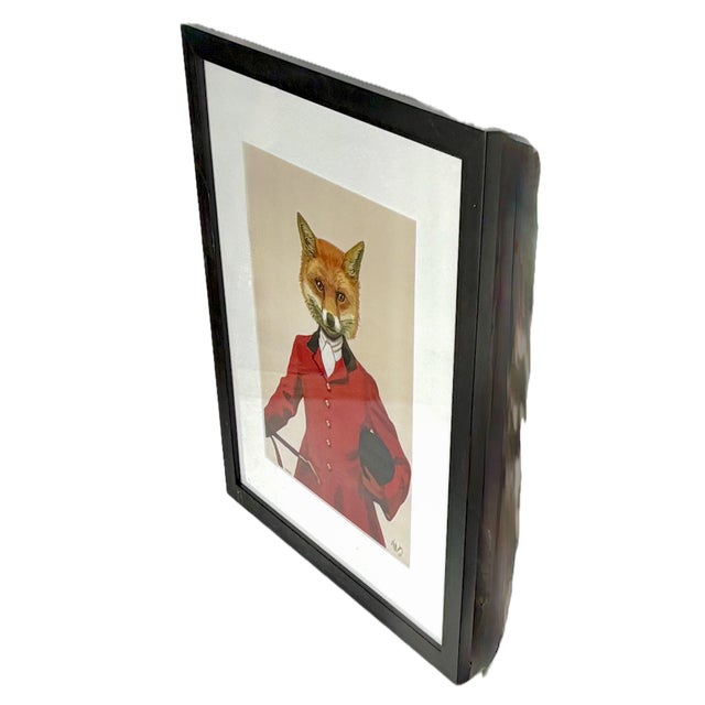 A charmingly ironic and witty framed print of a fox dressed in traditional English fox-hunting attire. With its clever...