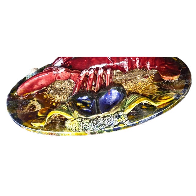 Original and wonderfully vintage, this large majolica earthenware platter features a trompe-l'oeil decoration of a...