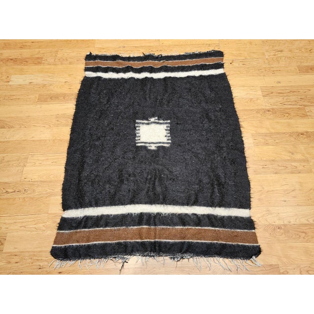 This beautiful vintage Turkish Tulu rug, handwoven in the second quarter of the 20th century, showcases the rich tradition...