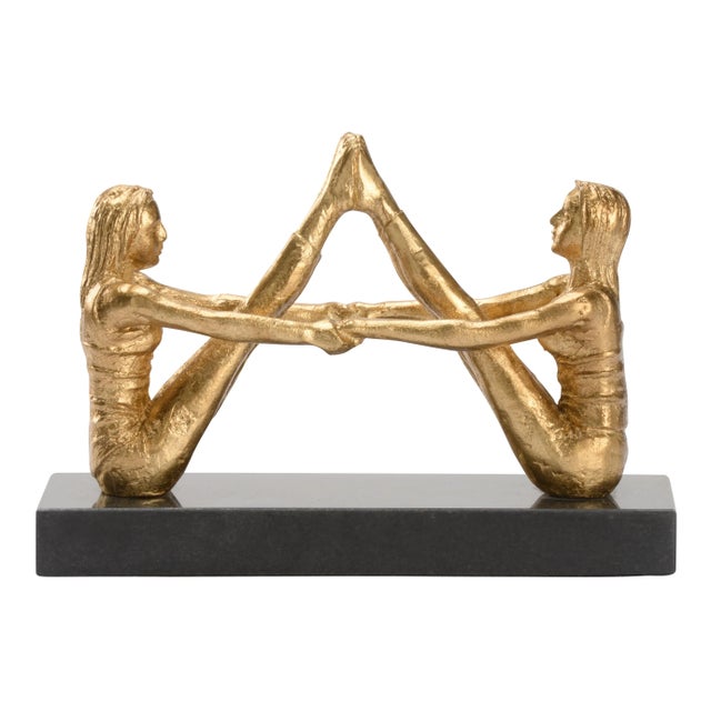 Designed for the yoga enthusiasts, this handcrafted sculpture features two women in navasana or boat pose. This metallic...
