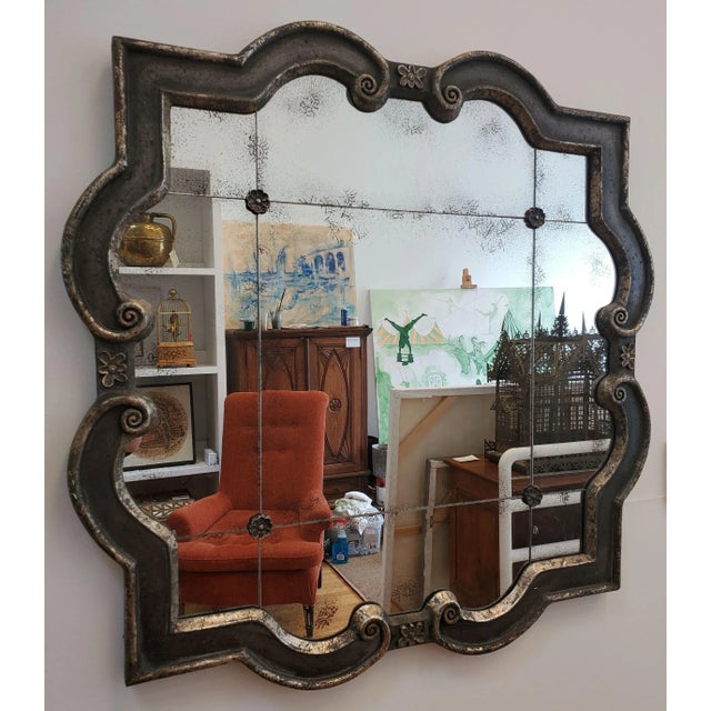 Brighten your home with this bold and sculptural Modern Art Deco-style mirror! Framed in a shapely, molded wood figure...