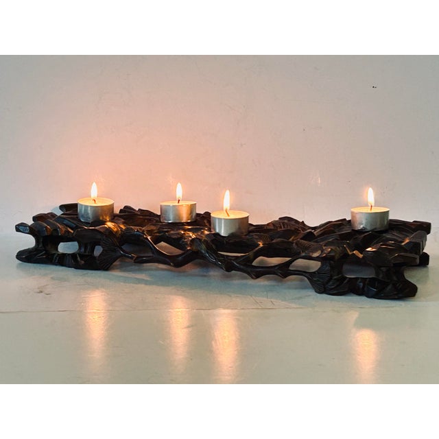 The finely carved & ebonized plateau in the form of open framework of pine tree limbs with etched fronds, rising from an...