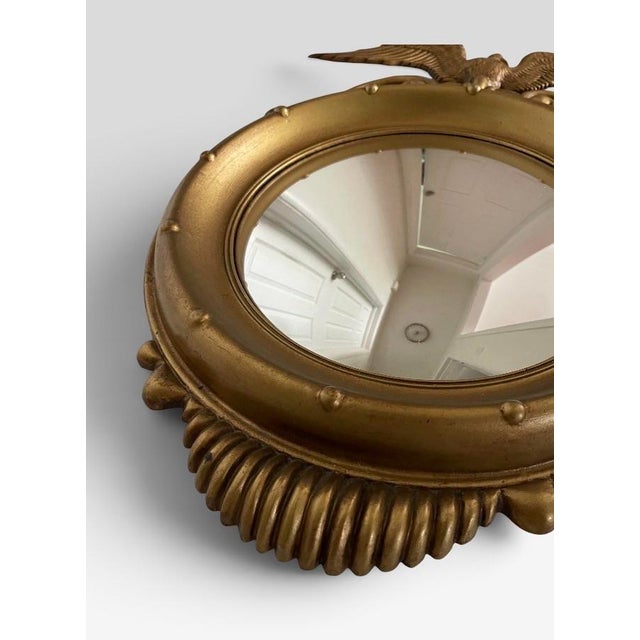 This 1970s Sexton Company federal design styled gold convex mirror is made from cast metal. Eerily similar to the Antique...