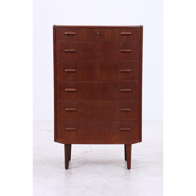 Vintage teak tallboy cabinet with six spacious drawers and a classic mid-century design. The warm teak grain and simple...