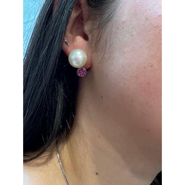 Presenting the exquisite 14mm Round South Sea Pearl & Ruby Cocktail Stud Earrings, a magnificent estate piece. These...