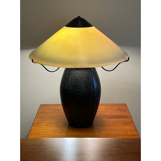 This Mission style arts and crafts hammered bronze metal amber light table lamp makes a statement in the room. It casts a...