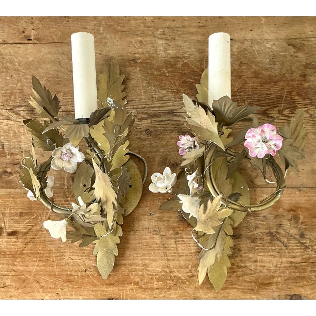 This exquisite pair of vintage wall sconces is a masterful celebration of mid-century French Regency elegance and...