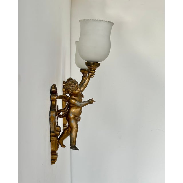 Pair of wall sconces with a gilt metal frame, produced in Italy in the 1950s. Classic design that has stood the test of...
