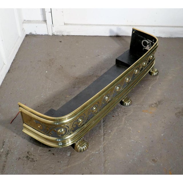 Arts & Crafts pierced brass fender. This is a Victorian pierced brass fender decorated with leaves and flower it has an...