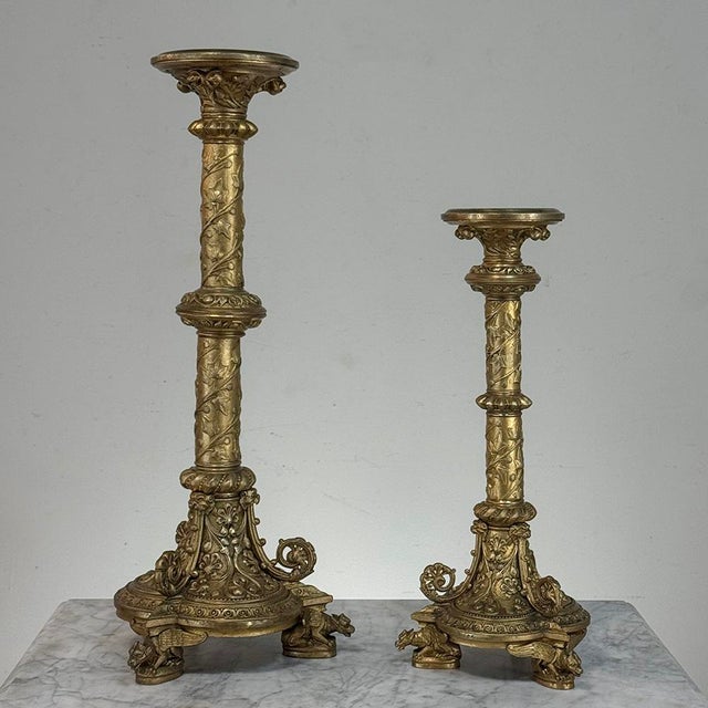 Richly sculpted in the French Renaissance Revival tradition, this set of two antique gilded bronze candlesticks features...