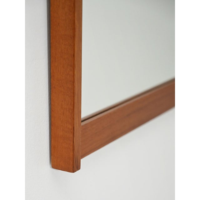 1960s mirror with teak frame featuring clean lines and slender proportions. Scandinavian mirror from the 1960s featuring a...