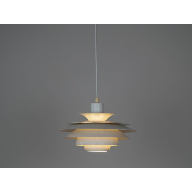 This lamp was designed by Danish designer Kurt Wiborg and manufactured by Jeka. The lamp's form is based on the principle...
