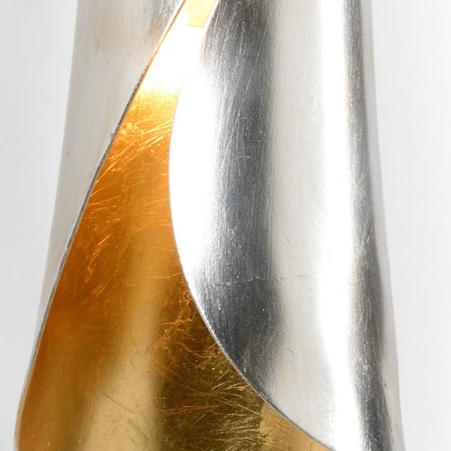 Antique silver leaf finished exterior with antique gold leaf interior cuff sconce. (Backplate: 5 1/8" x 3 1/4") 21.5h x...