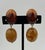 This fabulous pair of Retro Lucite Amber Orange Oval Dangle Earrings will stand the test of time. The autumn color palette...