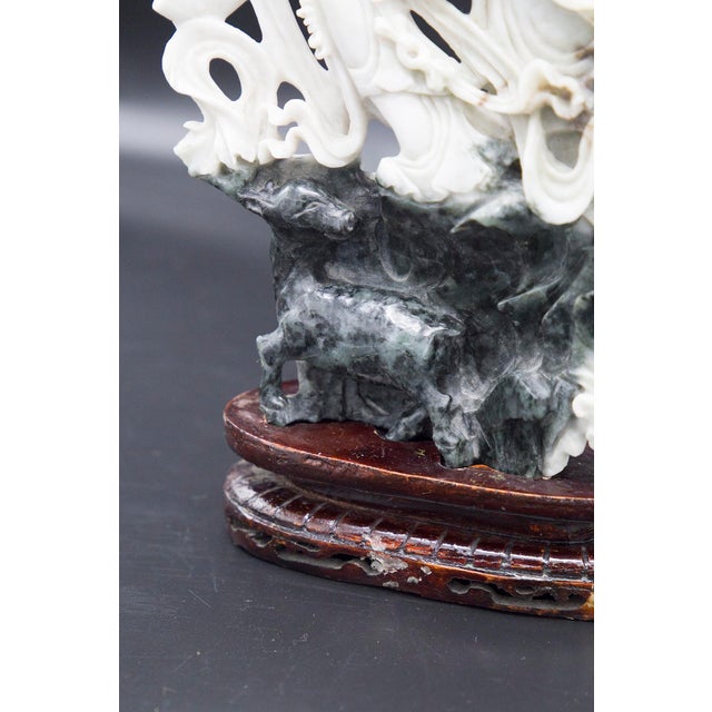 Splendid statue made of jade in the typically Chinese 19th century. The statue is very beautiful and rests on an oval base...