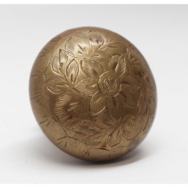 Single hollowed etched brass doorknob with floral detail. One available. The manufacturer and date of creation is unknown....