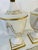 This is a pair of elegant Italian neoclassical-style porcelain urns or decorative lidded vases, likely mid-20th century....
